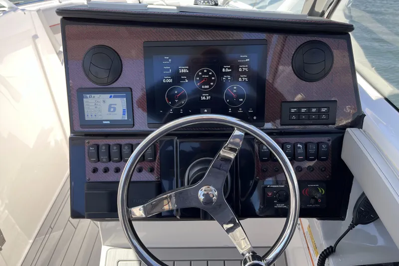 Slide: The Image of 2023 Solara S-250 DC boat dashboard with digital displays and steering wheel. - 8