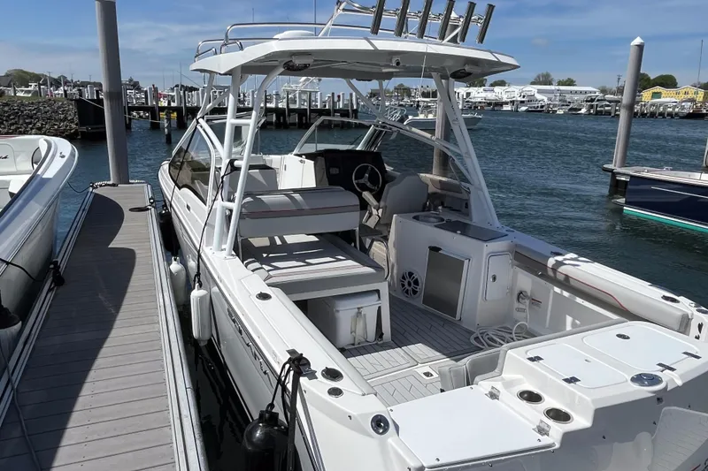 Slide: The Image of 2023 Solara S-250 DC boat docked at marina, featuring spacious deck and modern design. - 5