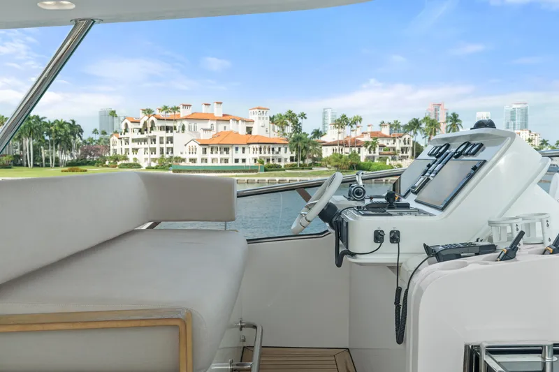 Slide: The Image of Flybridge of 2022 Azimut Grande 32 Metri yacht with luxurious seating and scenic waterfront view. - 28