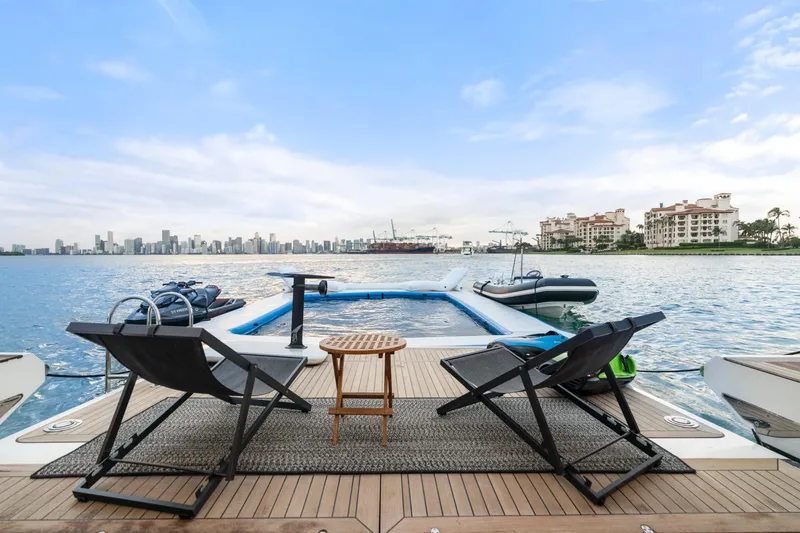 Slide: The Image of Luxury yacht deck with chairs, table, and ocean view; Azimut Grande 32 Metri, 2022 model. - 32