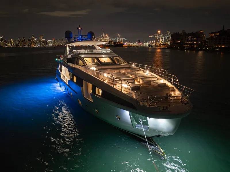 Slide: The Image of Luxurious 2022 Azimut Grande 32 Metri yacht illuminated at night in a city harbor. - 37