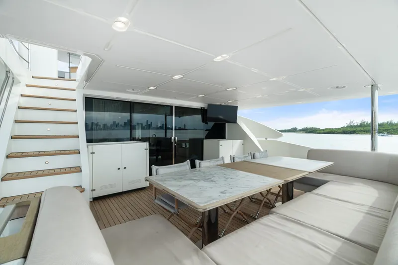 Slide: The Image of Luxurious 2022 Azimut Grande 32 Metri yacht deck with seating, table, and stairs. - 20
