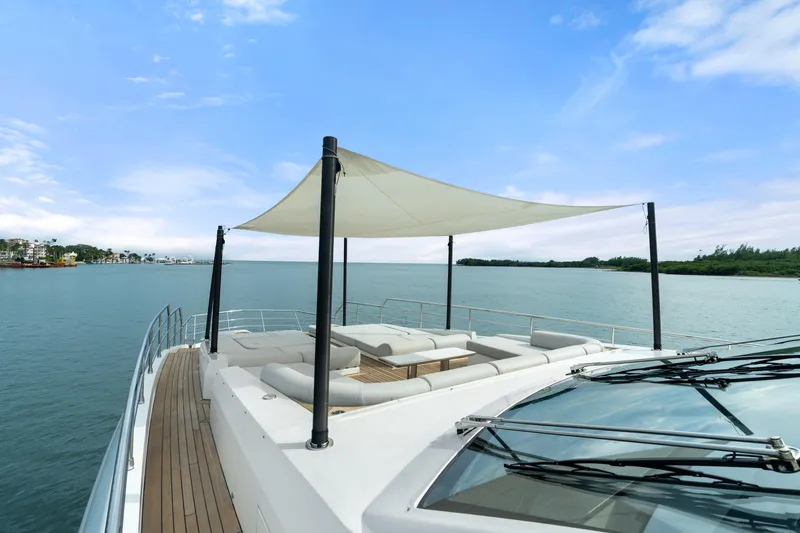 Slide: The Image of Luxurious Azimut Grande 32 Metri yacht deck with canopy, 2022 model, on serene water. - 22