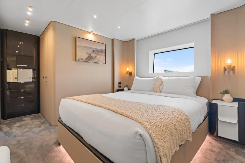 Slide: The Image of Luxurious bedroom interior of 2022 Azimut Grande 32 Metri yacht, featuring elegant decor and window view. - 16