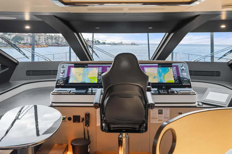 Slide: The Image of Cockpit of 2022 Azimut Grande 32 Metri yacht with navigation screens and captain's chair. - 33