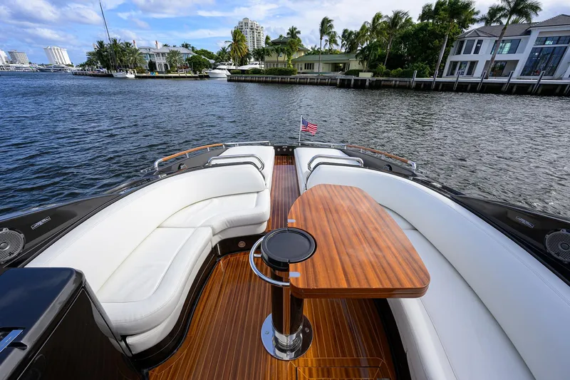 Slide: The Image of Luxurious 2014 Riva 44' Rivarama yacht with elegant seating and wooden table on deck. - 55