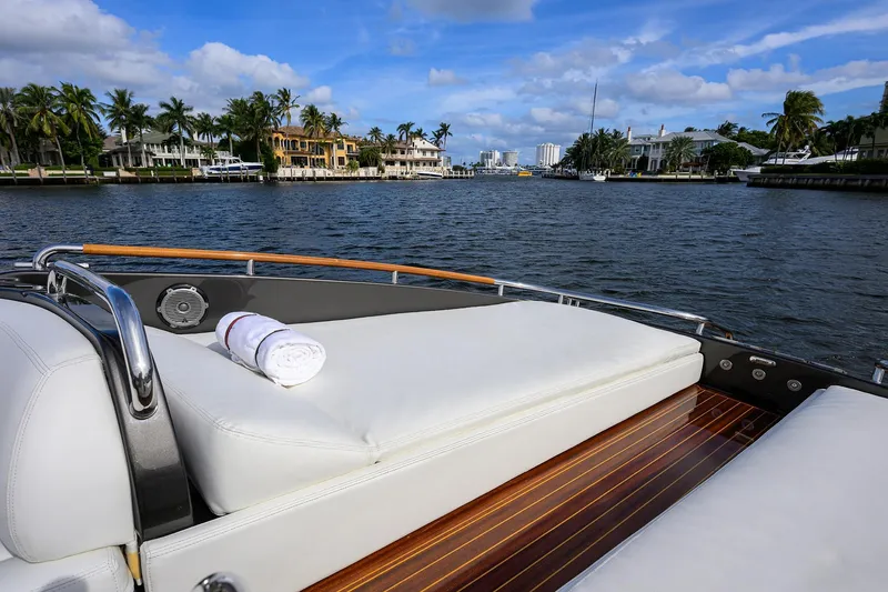 Slide: The Image of Luxurious 2014 Riva 44' Rivarama yacht cruising on a scenic waterway with palm trees. - 87