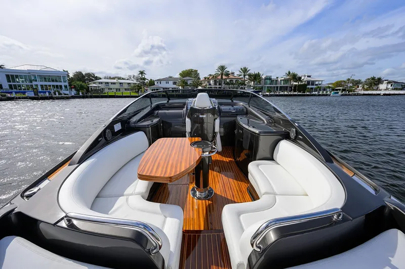 Slide: The Image of Luxurious 2014 Riva 44' Rivarama yacht with elegant seating and wooden deck on a scenic waterway. - 61