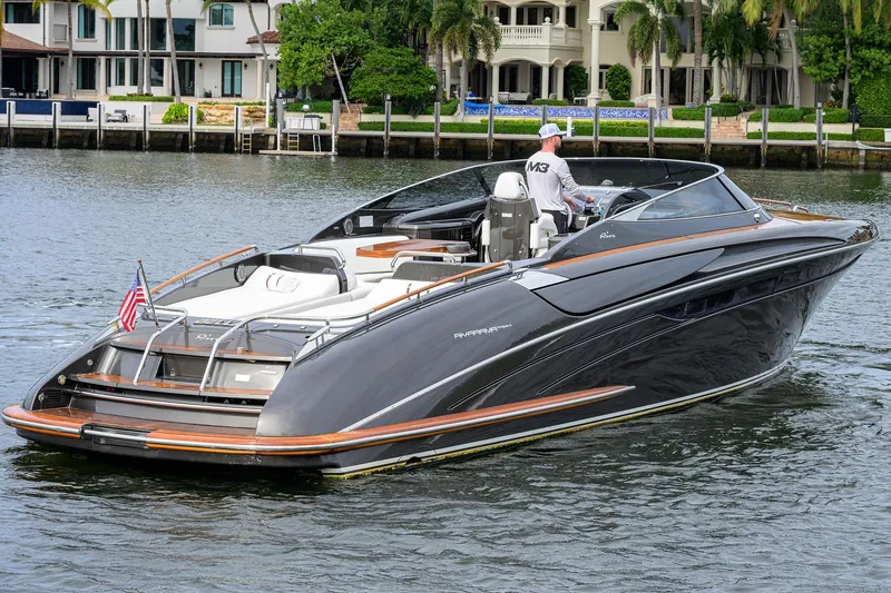 Slide: The Image of Luxurious 2014 Riva 44' Rivarama yacht cruising near waterfront homes. - 15