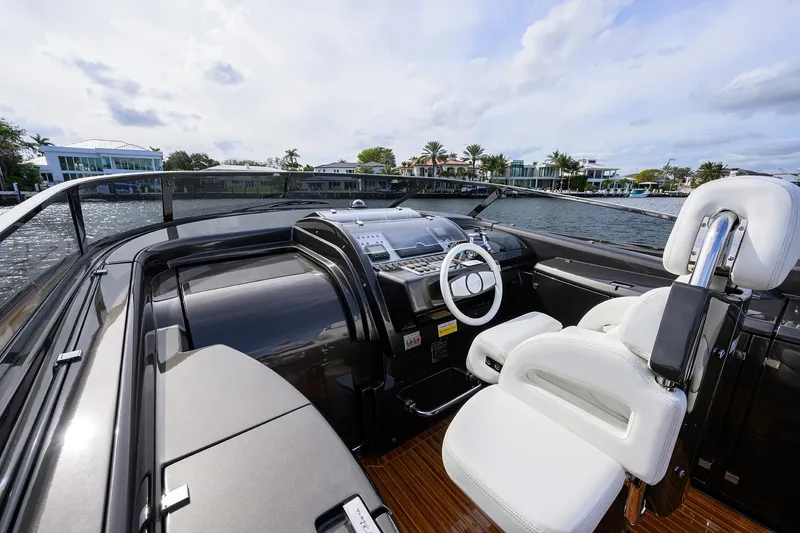 Slide: The Image of Luxurious 2014 Riva 44' Rivarama yacht cockpit with white leather seating and modern controls. - 22