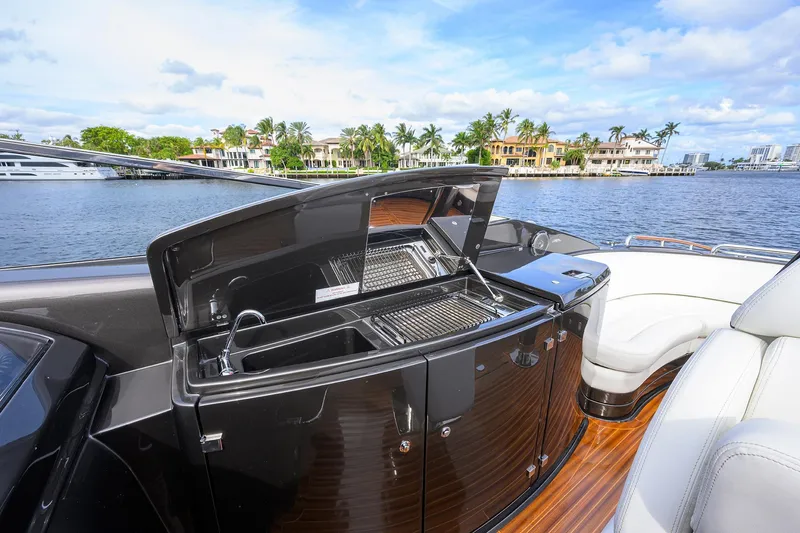 Slide: The Image of Luxury yacht Riva 44' Rivarama 2014 with outdoor kitchen and scenic waterfront view. - 48