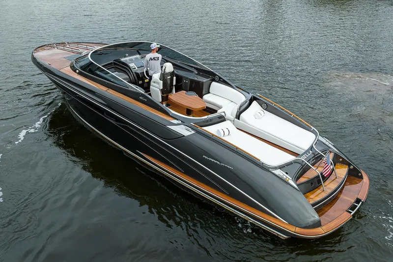 Slide: The Image of 2014 Riva 44' Rivarama luxury yacht cruising on water, featuring sleek design and elegant wood accents. - 10