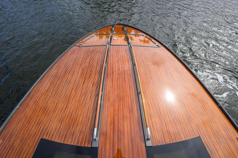 Slide: The Image of Luxurious 2014 Riva 44' Rivarama yacht with sleek wooden deck on water. - 86
