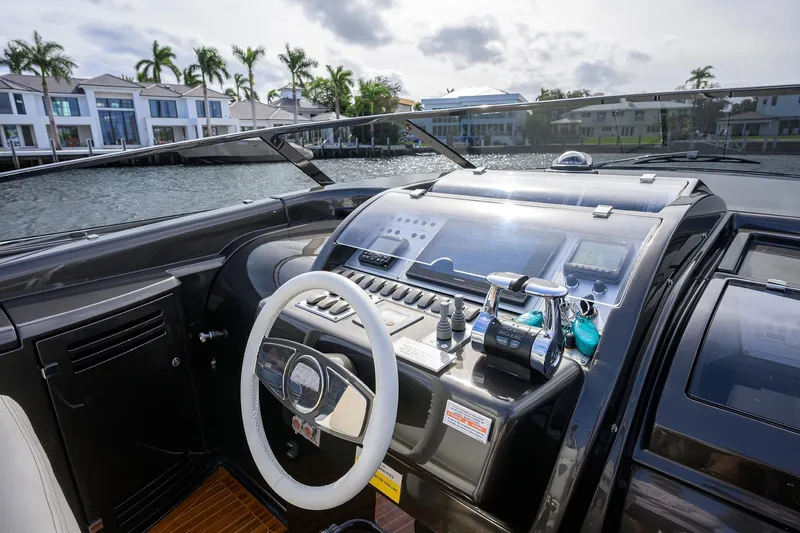 Slide: The Image of Cockpit view of 2014 Riva 44' Rivarama yacht with modern controls and waterfront backdrop. - 31