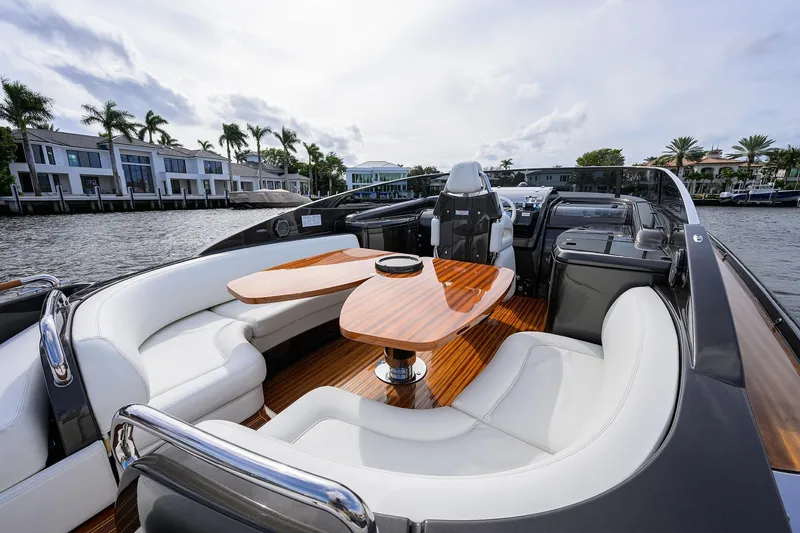 Slide: The Image of Luxurious 2014 Riva 44' Rivarama yacht with elegant seating and wooden table on deck. - 58