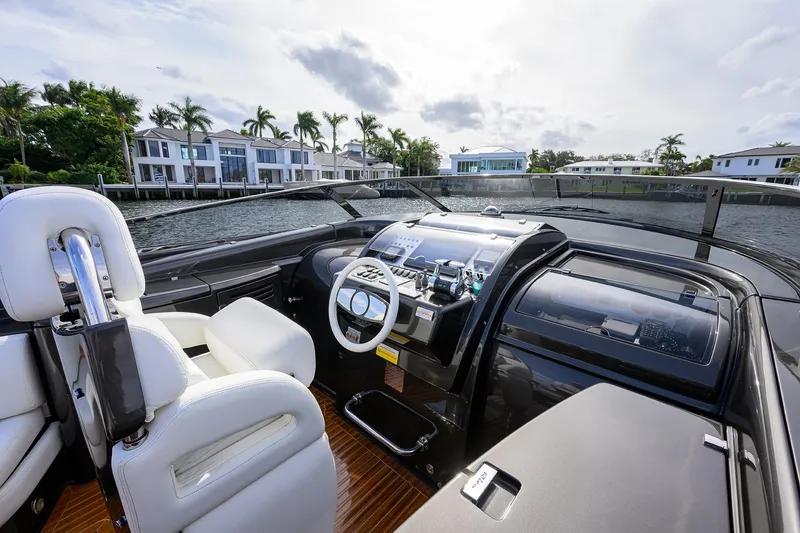 Slide: The Image of Cockpit of 2014 Riva 44' Rivarama yacht with luxurious white seating and modern controls. - 32