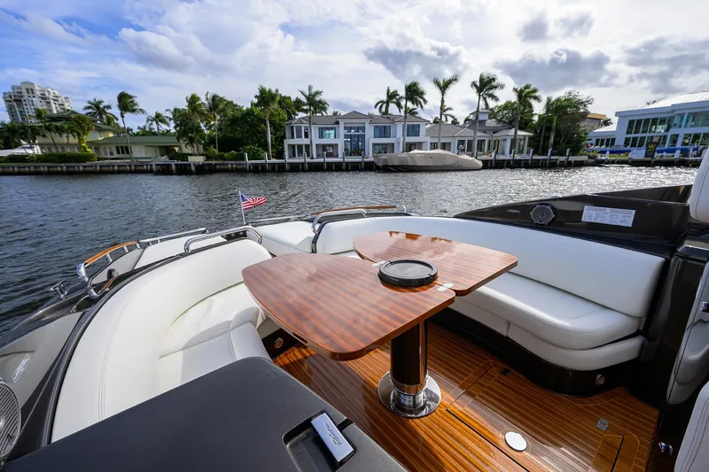 Slide: The Image of Luxurious 2014 Riva 44' Rivarama yacht with elegant seating and waterfront view. - 53