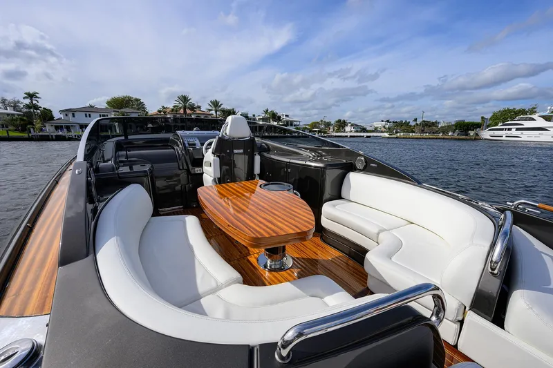 Slide: The Image of Luxurious 2014 Riva 44' Rivarama yacht with elegant seating and wooden table on deck. - 62