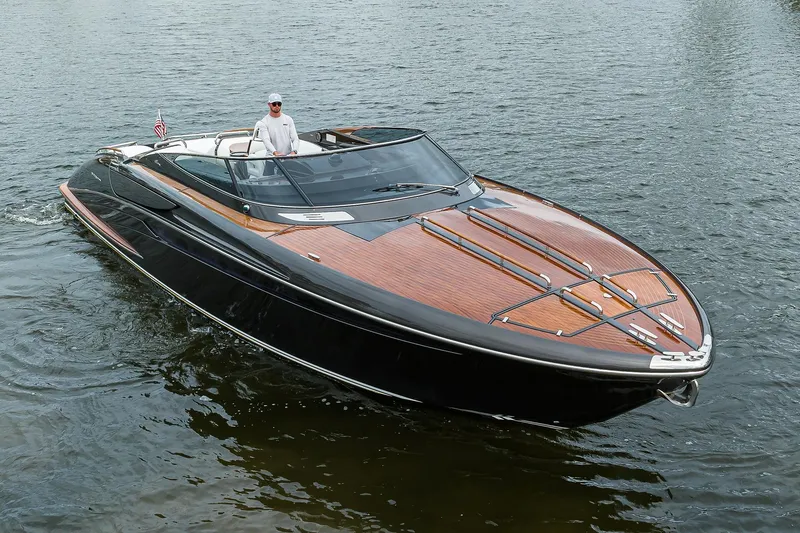 Slide: The Image of 2014 Riva 44' Rivarama luxury yacht cruising on water with a person onboard. - 13