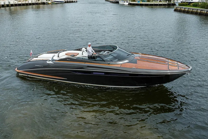 Slide: The Image of 2014 Riva 44' Rivarama luxury yacht cruising on calm waters. - 14