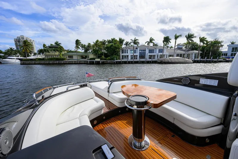 Slide: The Image of Luxurious 2014 Riva 44' Rivarama yacht with elegant seating and waterfront view. - 56