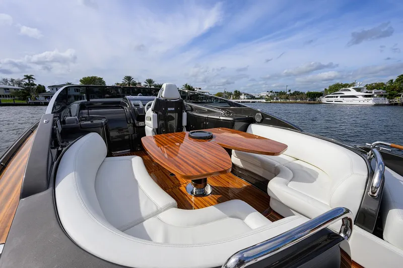 Slide: The Image of Luxurious 2014 Riva 44' Rivarama yacht with elegant seating and wooden table on deck. - 57