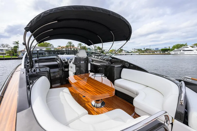 Slide: The Image of Luxurious 2014 Riva 44' Rivarama yacht with elegant seating and wooden table on deck. - 47
