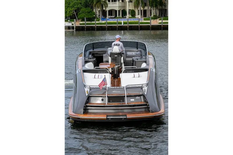 Slide: The Image of 2014 Riva 44' Rivarama luxury yacht cruising on a serene waterway. - 17