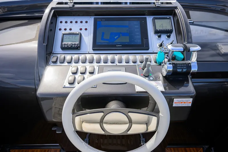 Slide: The Image of Dashboard of a 2014 Riva 44' Rivarama yacht with navigation controls and display. - 26