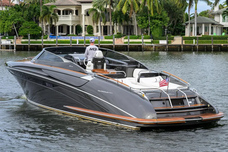 Slide: The Image of Luxurious 2014 Riva 44' Rivarama yacht cruising near waterfront homes. - 4
