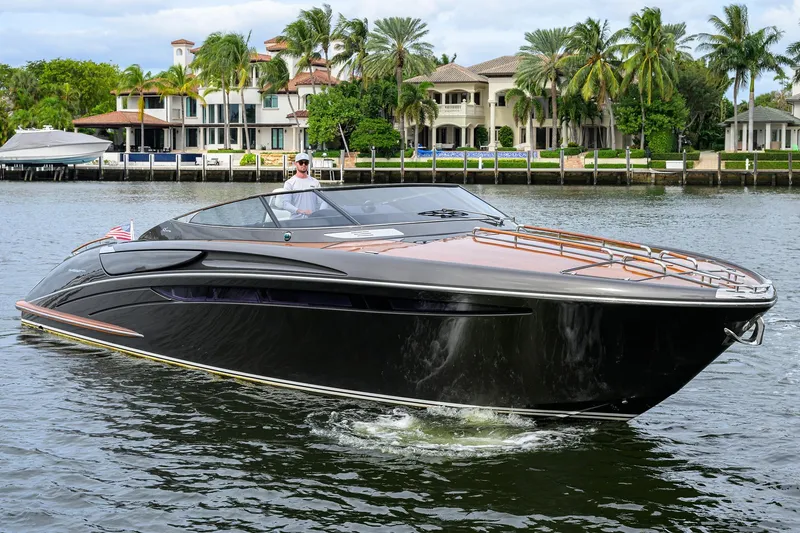 Slide: The Image of Luxurious 2014 Riva 44' Rivarama yacht cruising near waterfront mansions. - 3