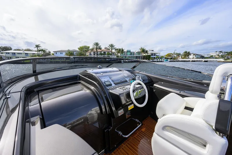 Slide: The Image of 2014 Riva 44' Rivarama yacht cockpit with luxurious white seating and modern controls. - 28