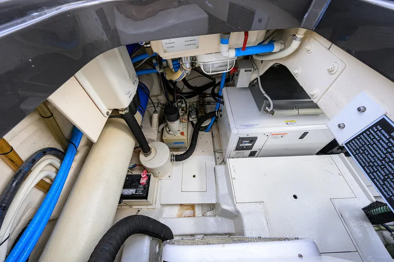 Slide: The Image of Engine compartment of 2014 Riva 44' Rivarama yacht, showcasing mechanical components and wiring. - 95