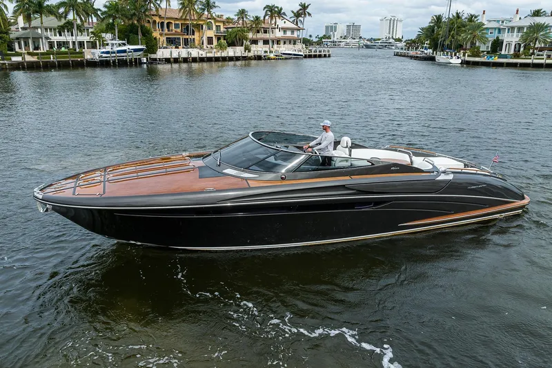 Slide: The Image of 2014 Riva 44' Rivarama luxury yacht cruising on a scenic waterway. - 11