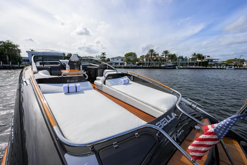 Slide: The Image of Luxurious 2014 Riva 44' Rivarama yacht with elegant deck, docked by waterfront homes. - 92