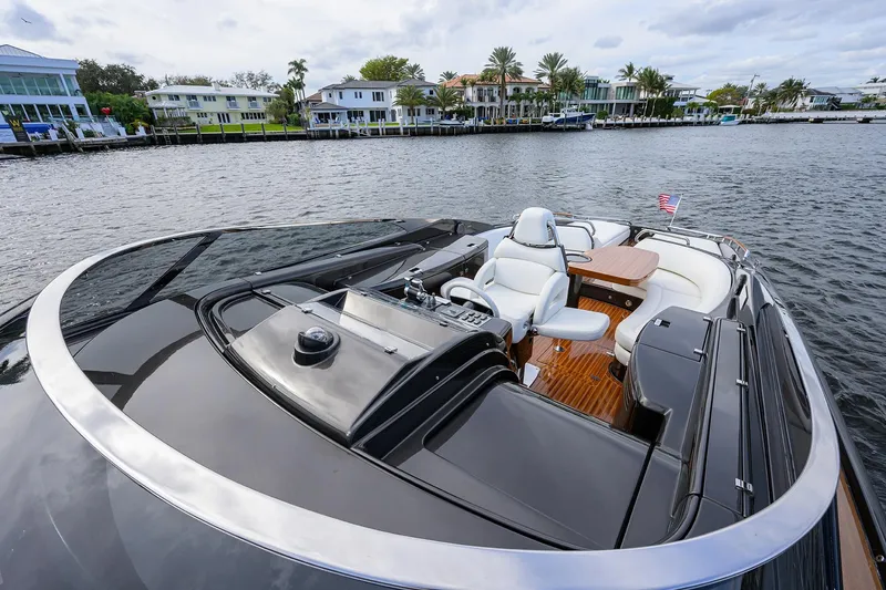 Slide: The Image of Luxurious 2014 Riva 44' Rivarama yacht with sleek design and elegant seating on the water. - 21