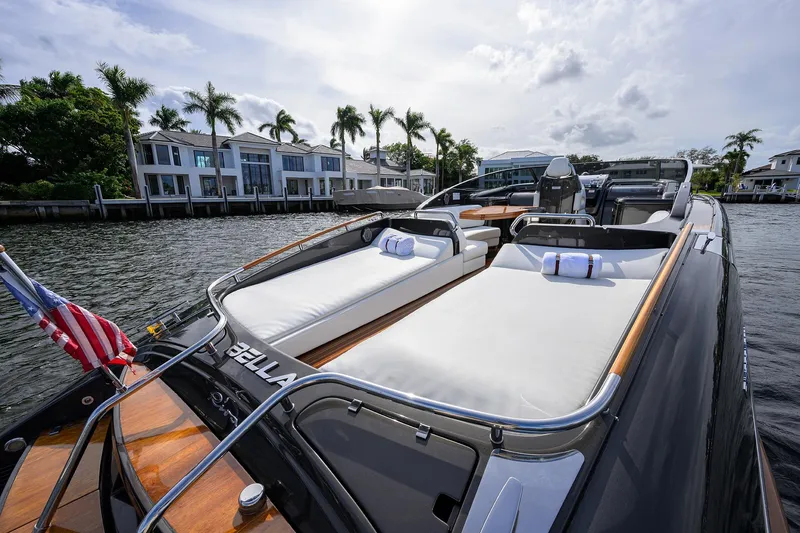 Slide: The Image of Luxurious 2014 Riva 44' Rivarama yacht with sunbeds, docked near waterfront homes. - 90