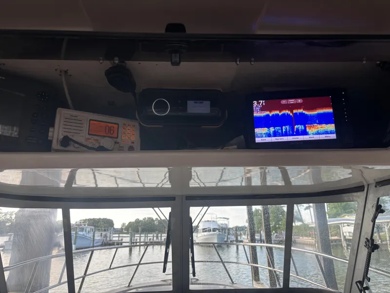 Slide: The Image of The image shows the cockpit of a 2004 True World Marine 286 boat with electronic equipment. - 2