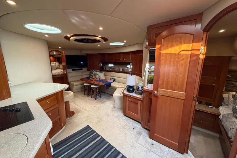 Slide: The Image of Luxurious interior of 2003 Cruisers Yachts 5470 Express with elegant wood finishes and modern amenities. - 25