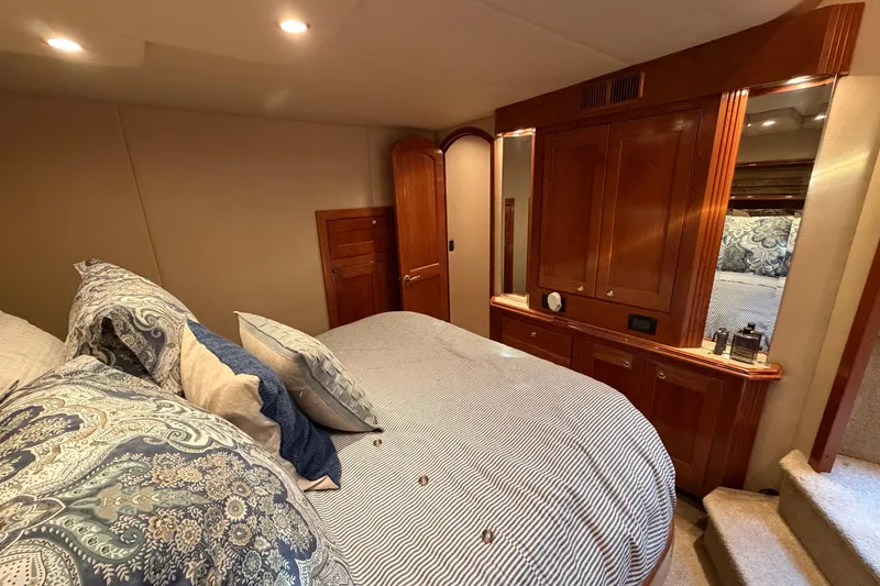 Slide: The Image of Luxurious bedroom interior of 2003 Cruisers Yachts 5470 Express with elegant wood cabinetry. - 36