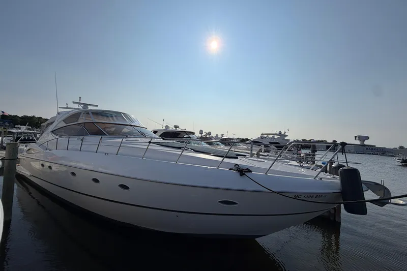 The Image of 2003 Cruisers Yachts 5470 Express docked under a clear sky. - 0