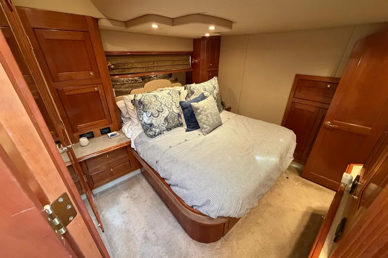 Slide: The Image of Luxurious bedroom interior of 2003 Cruisers Yachts 5470 Express with elegant wood cabinetry. - 34