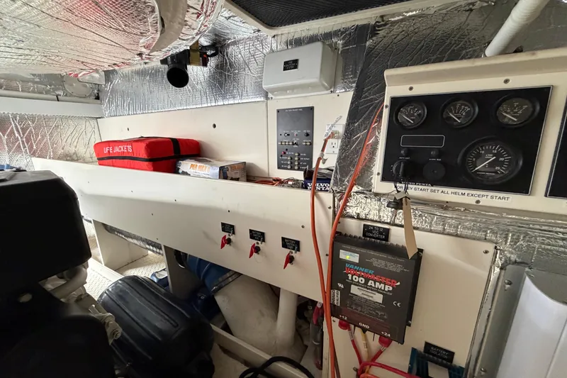 Slide: The Image of Engine room of 2003 Cruisers Yachts 5470 Express with control panels and safety equipment. - 44