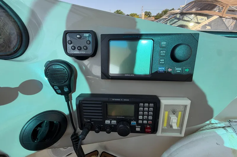 Slide: The Image of Control panel of a 2003 Cruisers Yachts 5470 Express with navigation and communication equipment. - 22