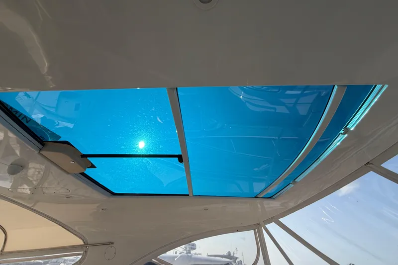 Slide: The Image of Sunroof view from 2003 Cruisers Yachts 5470 Express, showcasing bright blue sky. - 23