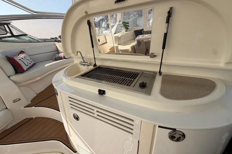 Slide: The Image of 2003 Cruisers Yachts 5470 Express interior with grill and seating area. - 14