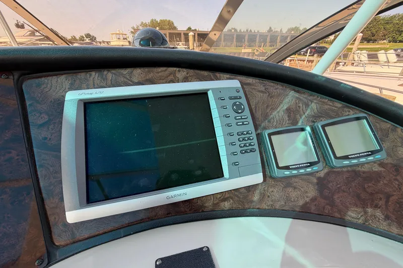 Slide: The Image of Garmin GPS and Volvo Penta displays on 2003 Cruisers Yachts 5470 Express dashboard. - 21