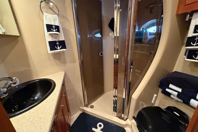 Slide: The Image of Luxurious bathroom in 2003 Cruisers Yachts 5470 Express with nautical decor. - 37