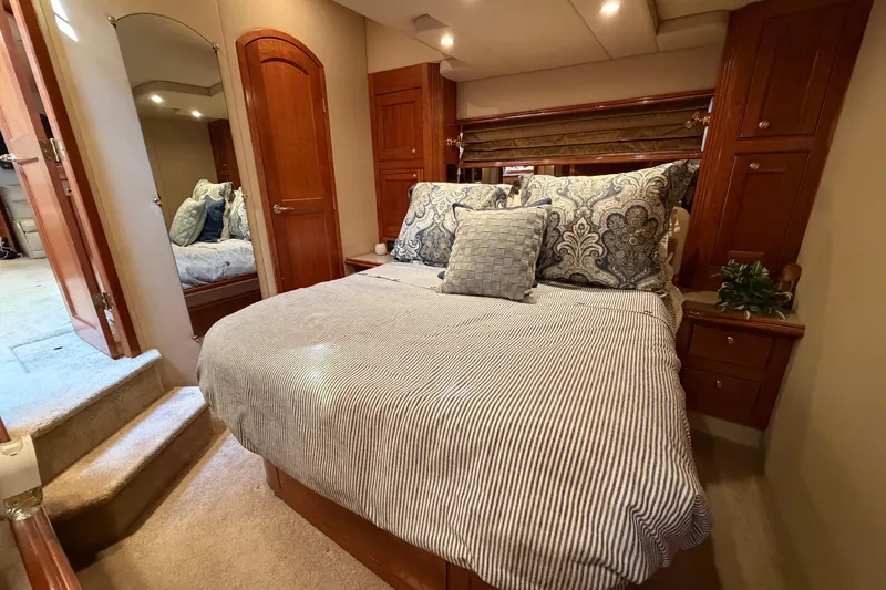 Slide: The Image of Luxurious bedroom interior of 2003 Cruisers Yachts 5470 Express with elegant bedding and wood accents. - 35