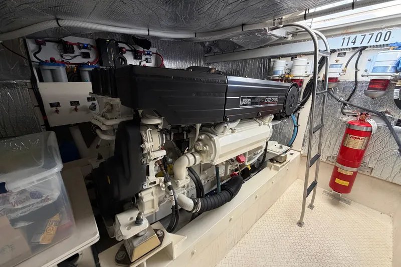 Slide: The Image of Engine room of 2003 Cruisers Yachts 5470 Express with Volvo Penta engine and fire extinguisher. - 41